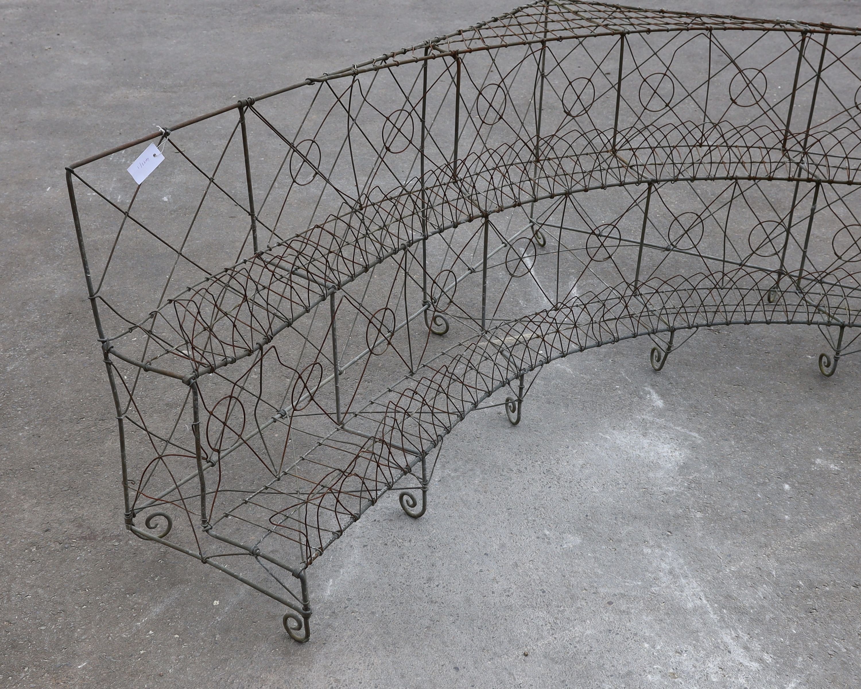 A wirework three tier corner pot stand, width 154cm, depth 180cm, height 68cm